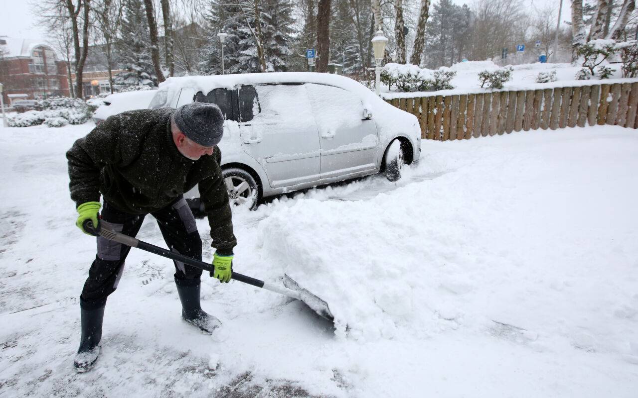 Hoteltechniker Thomas Paul räumt den Schnee in der Zufahrt zum Hotel in der Ortschaft Malente im Kreis Ostholstein.