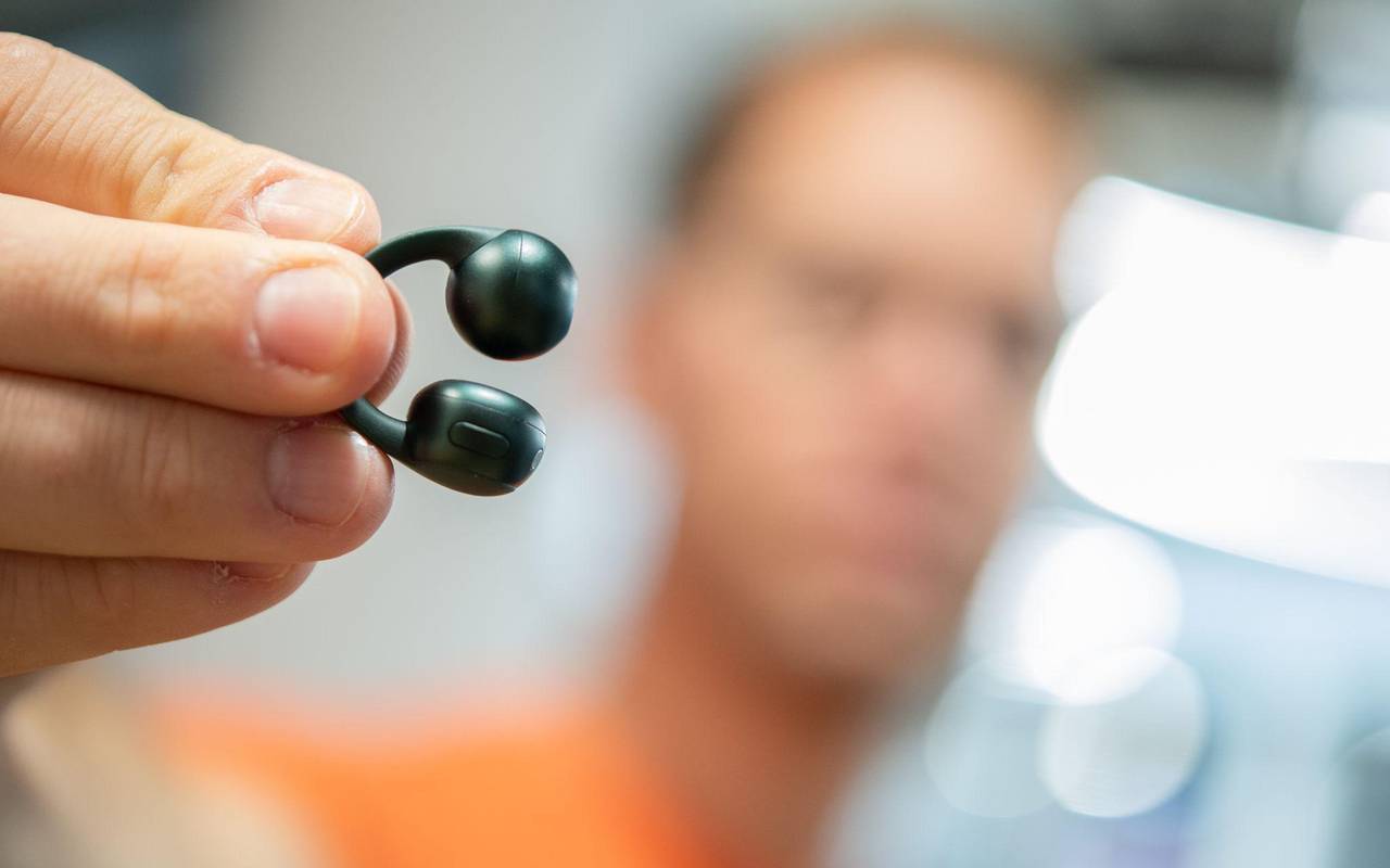 Mann hält die Moto Buds Loop von Motorola in der Hand
